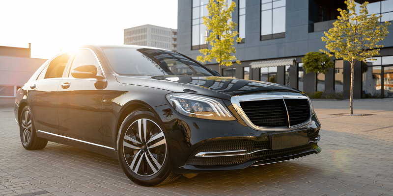 Interior of a luxurious limousine with ambient lighting.